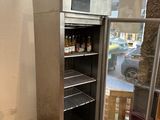 une photo d'un réfrigérateur vide dans un coin d'une pièce