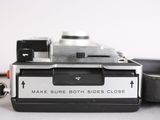 a close up of an old camera on a table