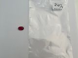 a plastic bag with a small red object in it