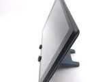 a tablet computer sitting on a stand on a white surface