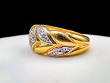 an image of a gold and diamond ring on a plate