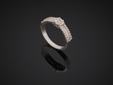 a white gold ring with diamonds on a black surface
