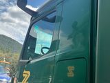a green semi truck parked on the side of the road