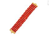 a close up of a red bracelet on a white background