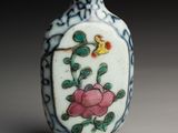 a small vase with a flower on it on a table