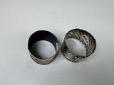 pair of antique silver bangles on a white surface