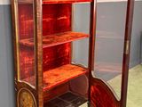 a cabinet that has a mirror on the top of it