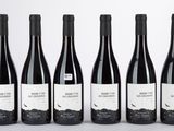 six bouteilles de vin sont alignées dans une rangée