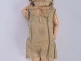 a doll that is standing up on a white surface