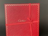a close up of a red box with a ribbon around it
