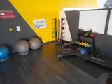 a gym room with a variety of exercise equipment