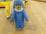 a lego figure sitting on a table next to a box of legos