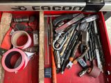 a red tool box filled with tools and a roll of tape