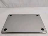 a silver laptop computer sitting on a white surface