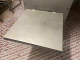a metal table with a metal tray on top of it