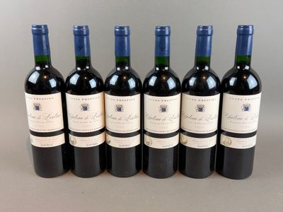 six bottles of wine are lined up in a row on a table