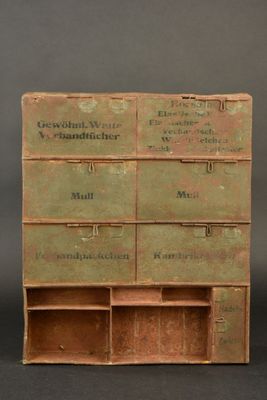 an old wooden cabinet with many drawers on it