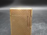an image of a gold cigarette case sitting on top of a table