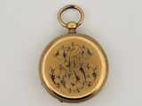 a gold pocket watch on a white surface