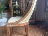 a chair that is sitting in front of a cabinet