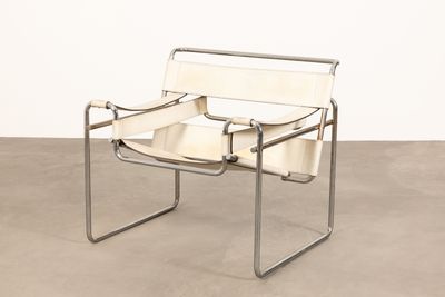 an image of a white leather chair on a concrete floor