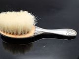 a brush with a white bristles on a black surface