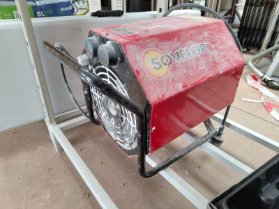 a small red machine that is sitting on a stand