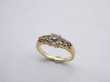 a close up of a gold ring with three diamonds on it