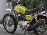 a green motorcycle parked on the side of the road