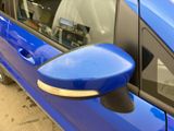 a blue car with a mirror on the side of it