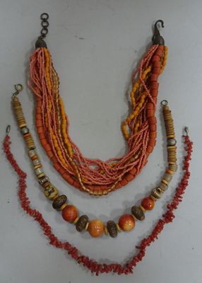 necklace made of multi - colored beads and wooden beads on a white surface