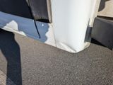 a close up of a truck ' s fender on the road