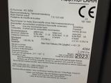 the label on the back of a black refrigerator is clearly visible