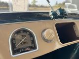 a close up of a dashboard with a clock on it