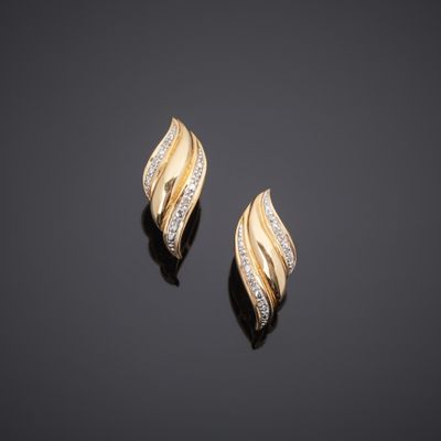 a pair of gold and diamond earrings