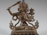 an image of a bronze statue of a person holding a sword
