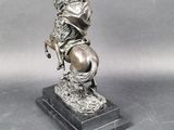 statue of a man on a horse on a base with a hat on