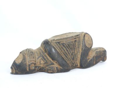 an old figurine of a dog laying down on its side