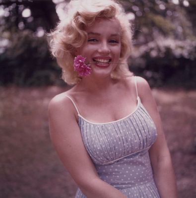 a woman with a flower in her mouth posing for a picture