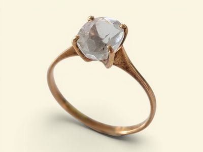 a close up of a ring with a diamond on it