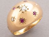 an image of a gold ring with diamonds and rubies on it
