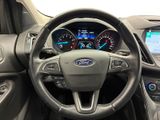the interior of a car with a steering wheel and dashboard controls