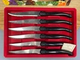 six knives in a red box on a table