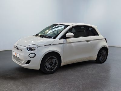 the small white car is parked in a large room