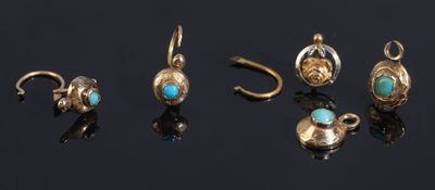 five pairs of gold and turquoise stone earrings on a black surface