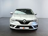 the front view of a white car parked in a showroom