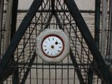 a clock that is in the middle of a cage