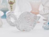 a lot of glass vases sitting on a table