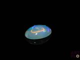an image of a white fire opal in the dark
