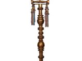 a gold metal table lamp with tassels hanging from it ' s base